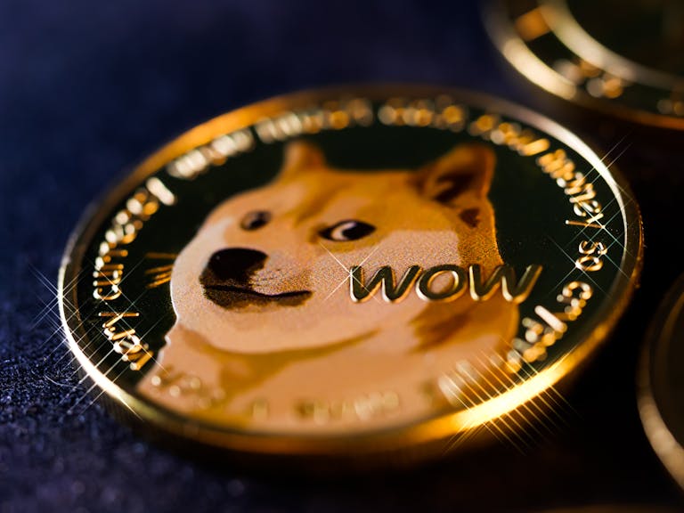 Detailed close-up image of a shiny Dogecoin cryptocurrency coin with the iconic Shiba Inu dog.